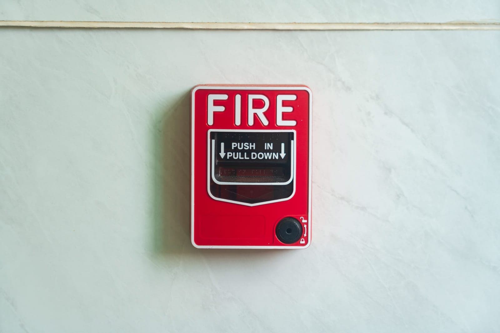 A carbon monoxide alarm mounted on a wall in a home.