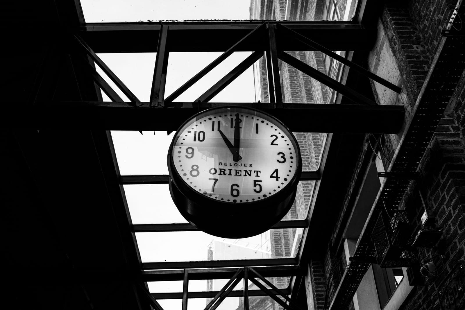 A clock beside running machinery.