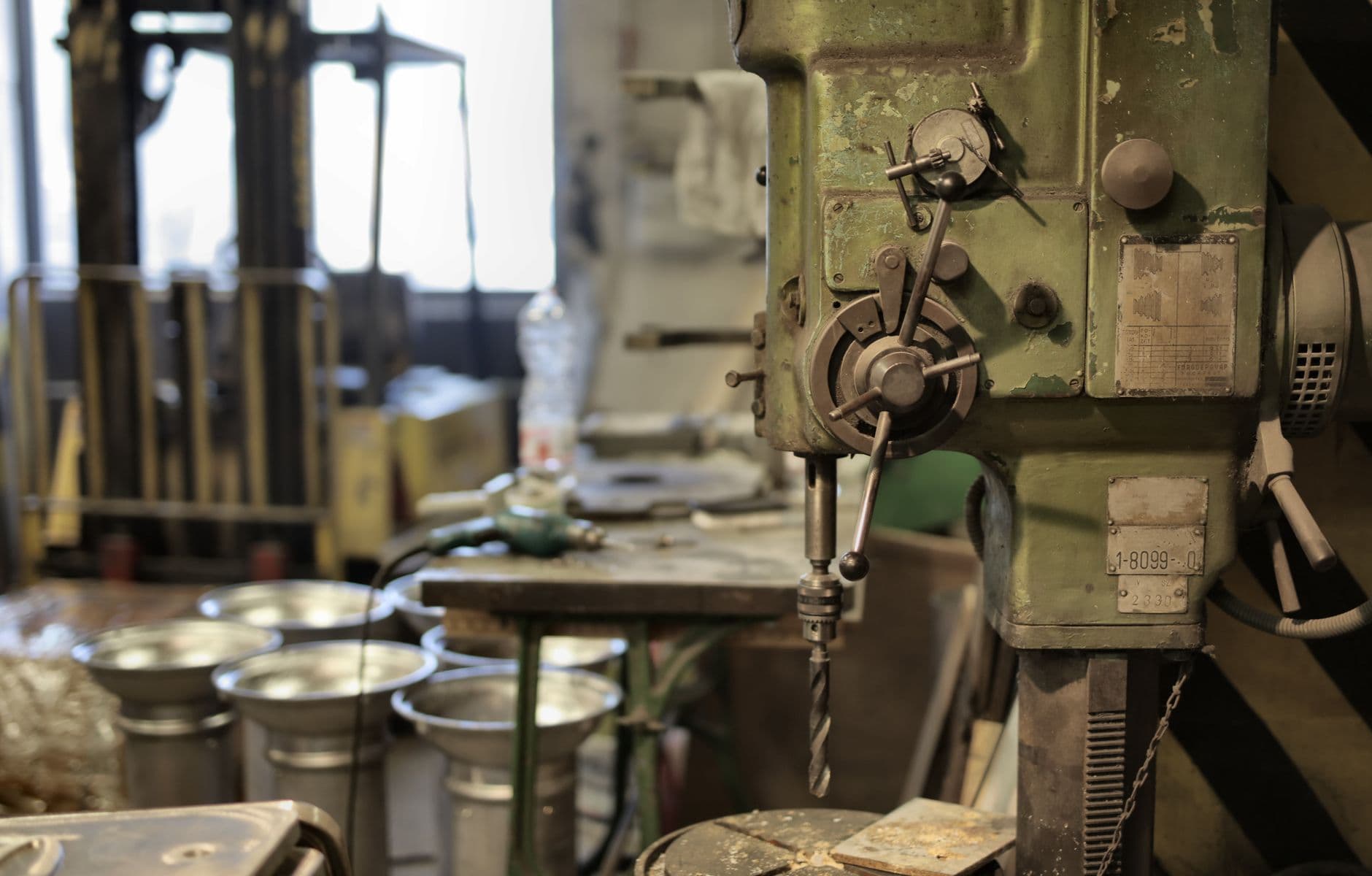 An industrial machine standing in an empty workshop.