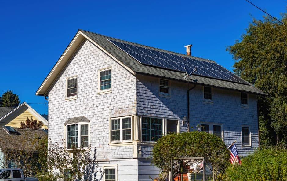 A two-story home with solar panels on its roof.