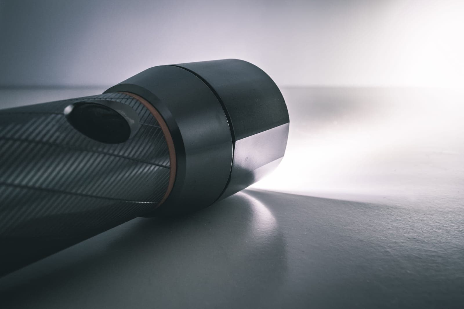 A flashlight beam illuminating a dark hallway.