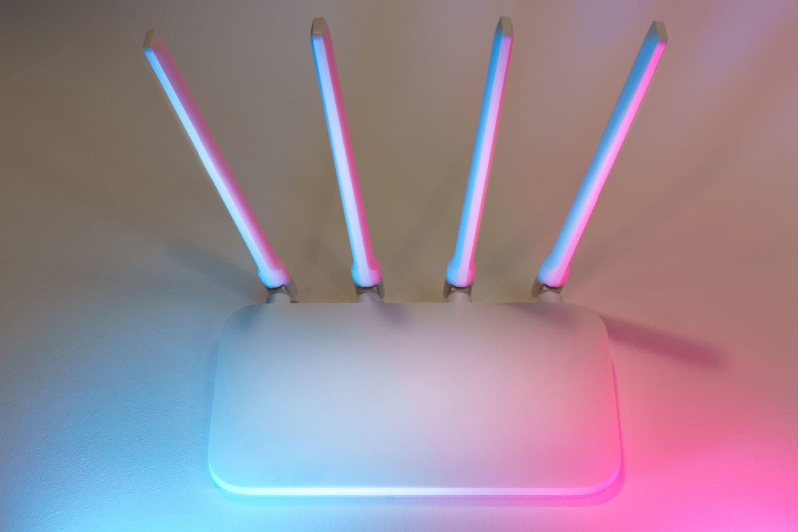 A wifi router with status lights on a shelf.
