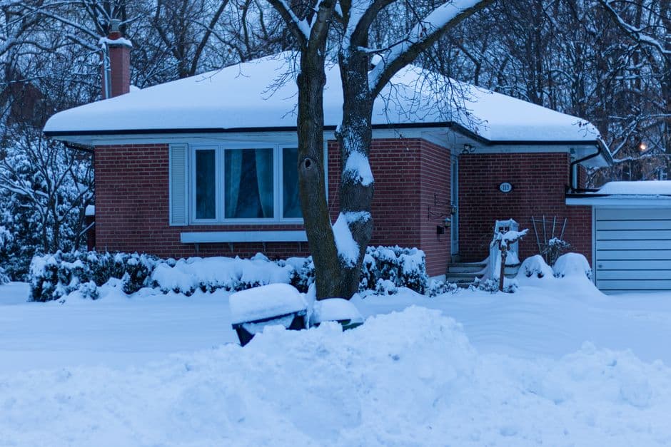 A snow-covered house on a winter morning.
