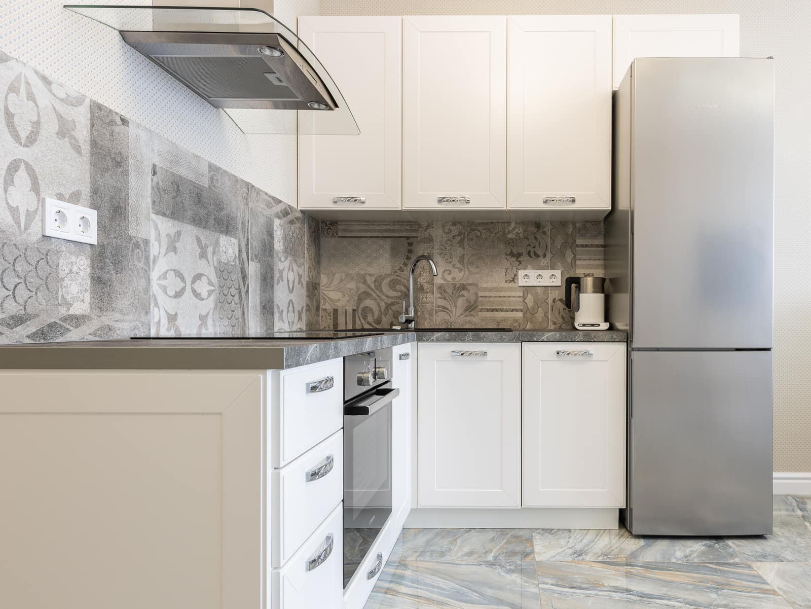 A modern refrigerator in a kitchen interior.