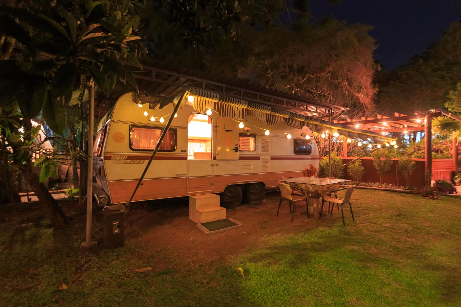 A camper van at a campsite in the evening.