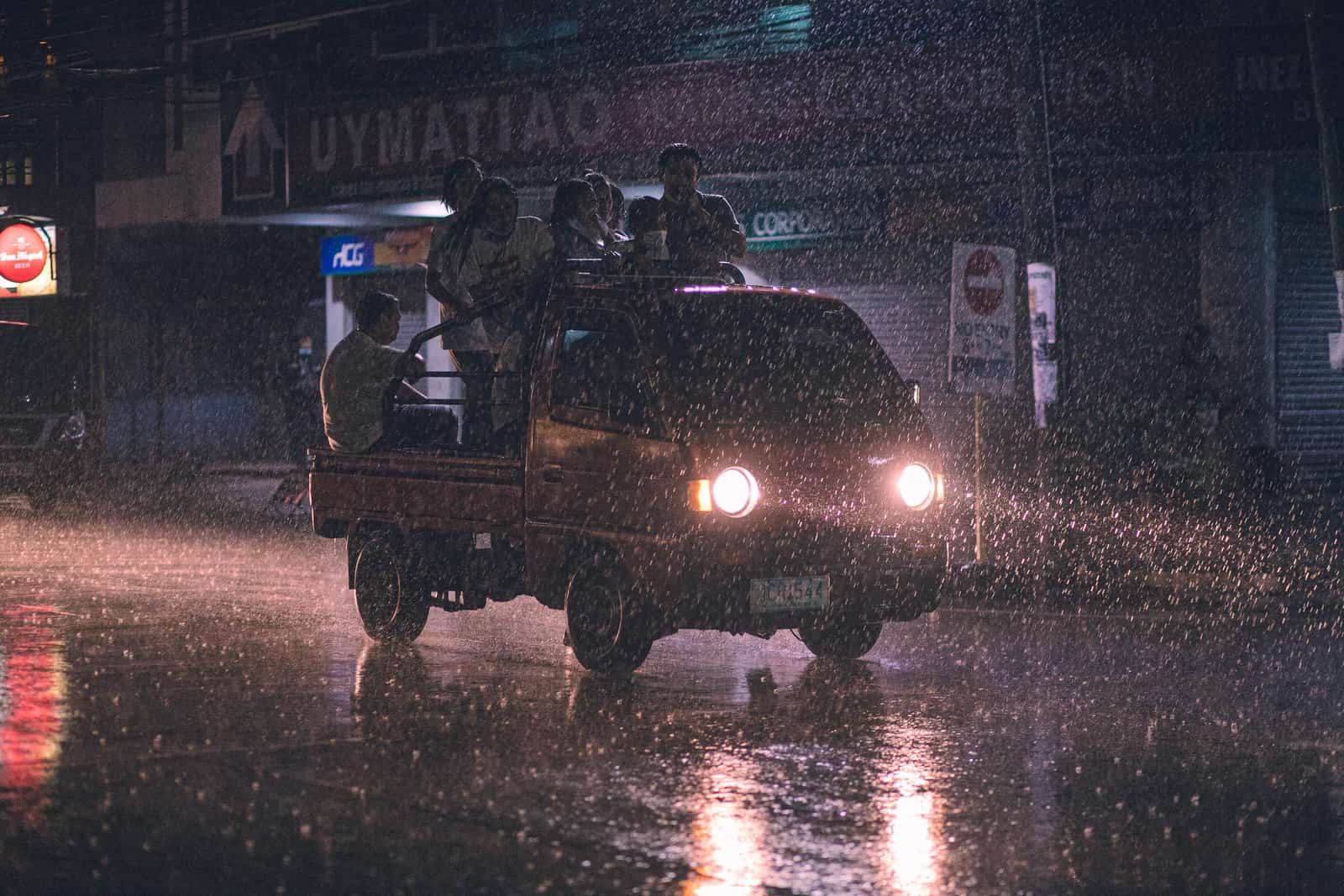 Heavy rain falling on a suburban street at night.
