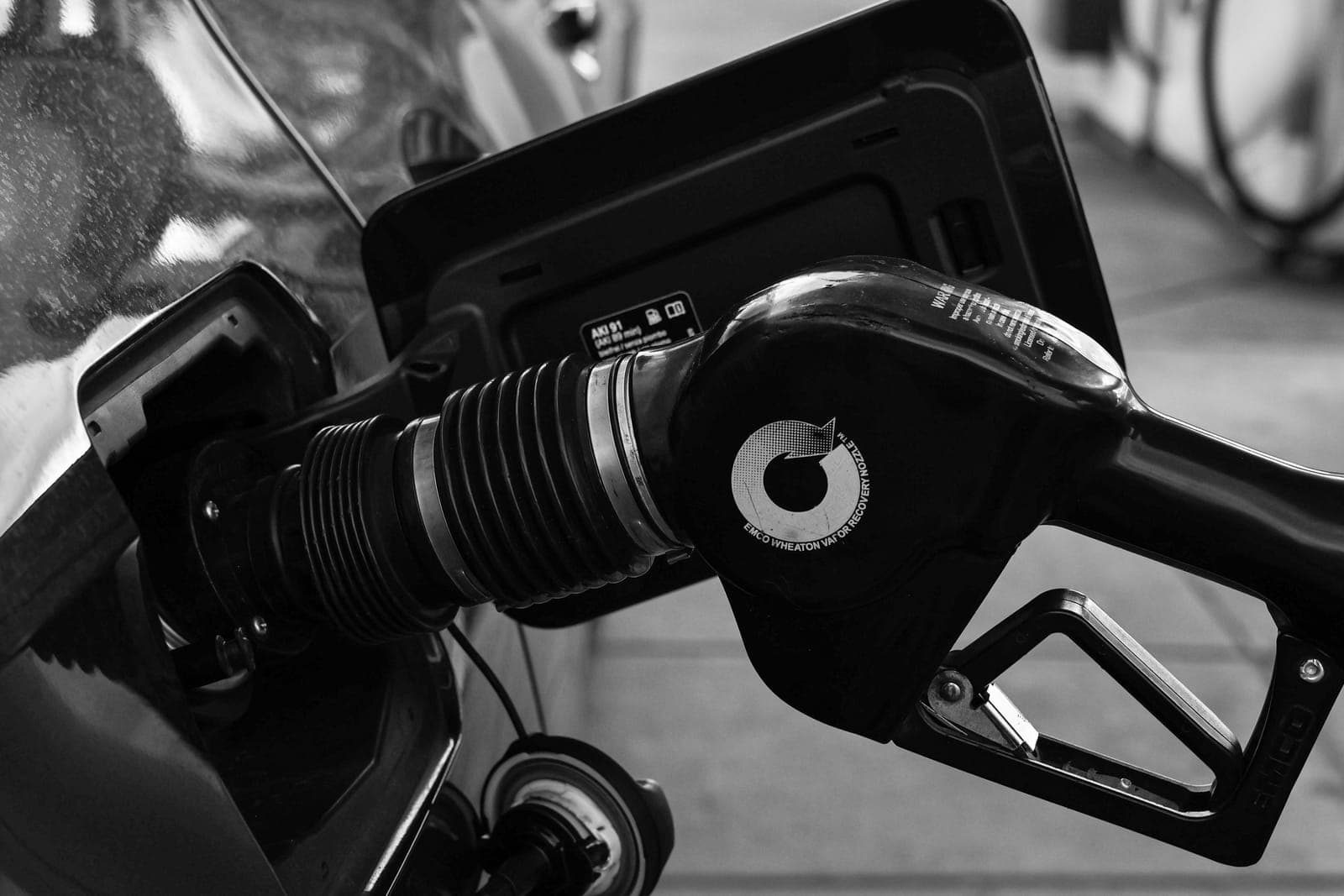 A fuel gauge and a gasoline pump nozzle.