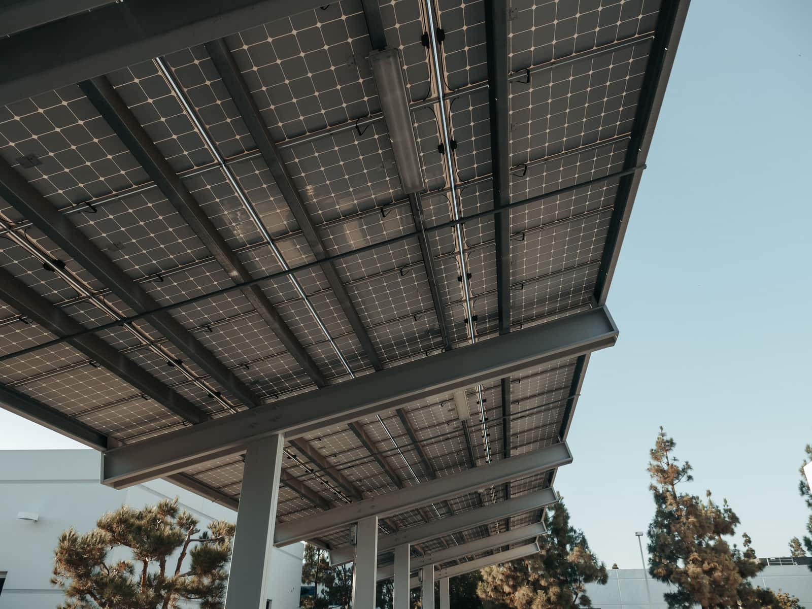Solar panels and a battery unit set up outdoors in sunlight.