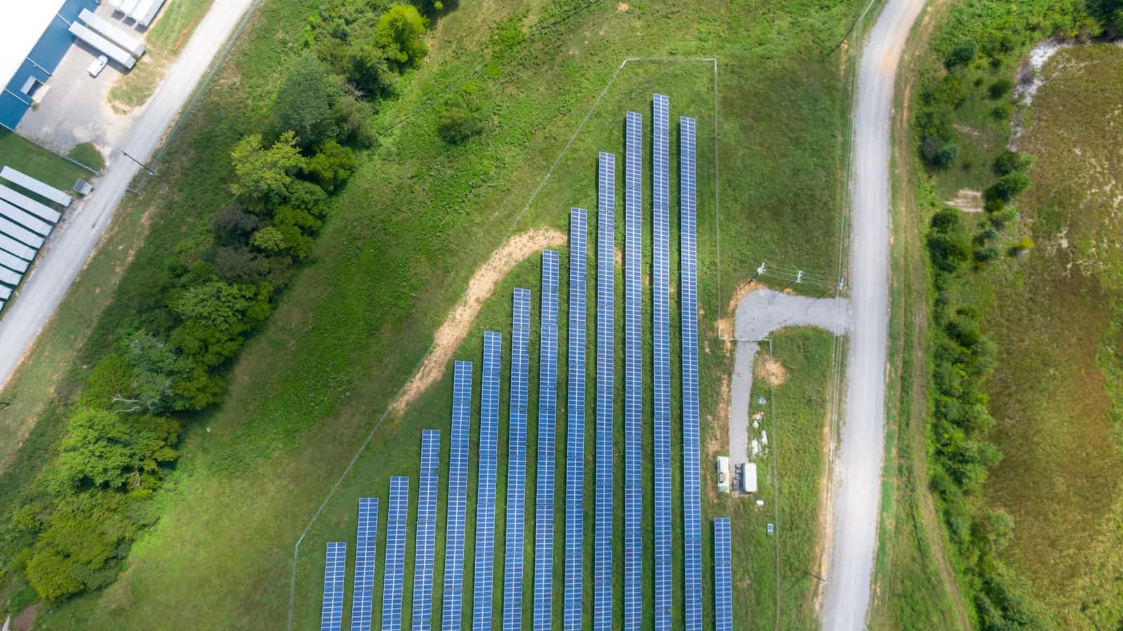 A solar panel and a fuel can standing on grass.