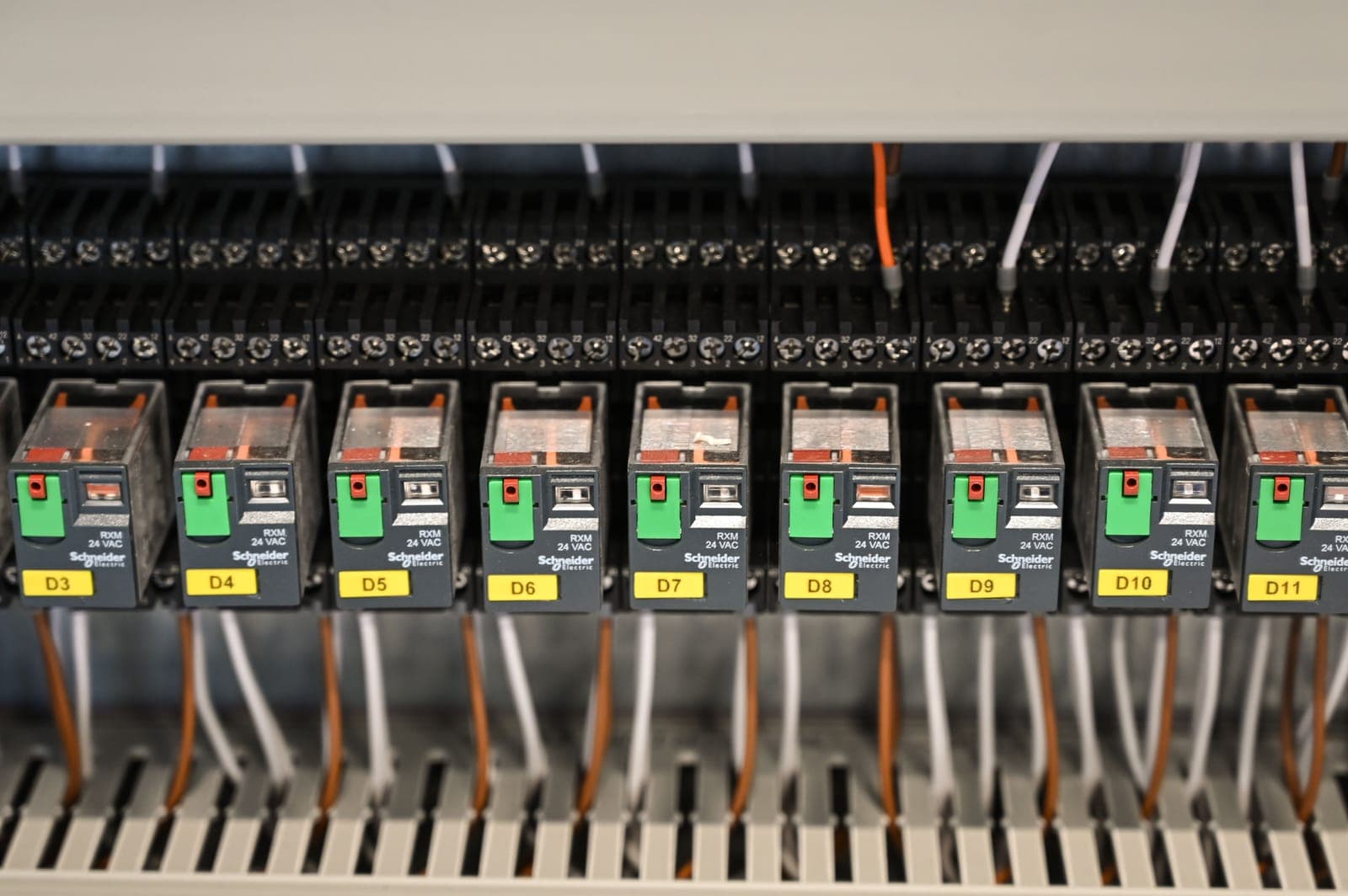 A circuit breaker panel with switches, photographed close up.