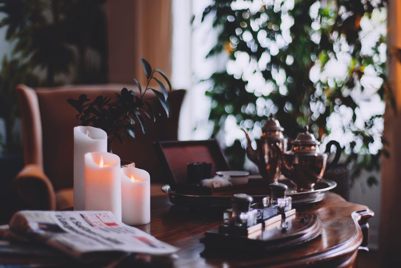 Candles and a flashlight on a table in a room during a power outage.