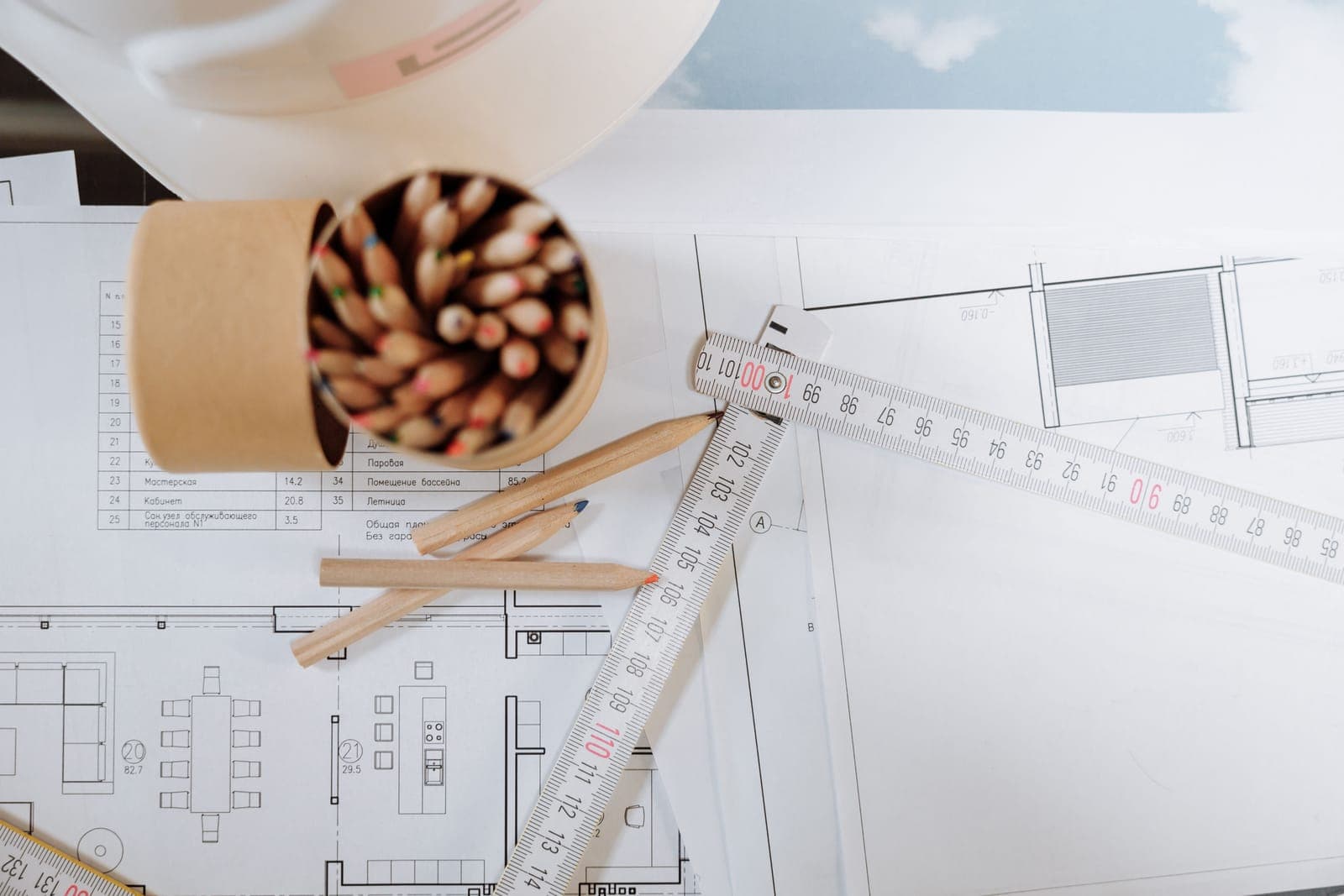 Engineering drawings and a ruler on a desk.